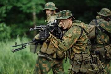 Fototapeta premium Group of soldiers special forces during the raid in the forest