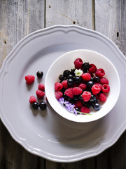 Summer berries in white bowl.