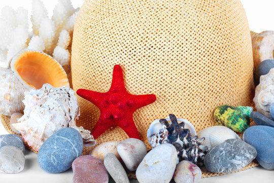 Pretty straw hat with starfish, pebble and  mussel