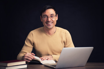 smiling handsome man reading a book
