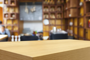 Empty wooden table and blurred cafe background