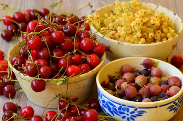 Cherries, currants and gooseberries in vintage bowls