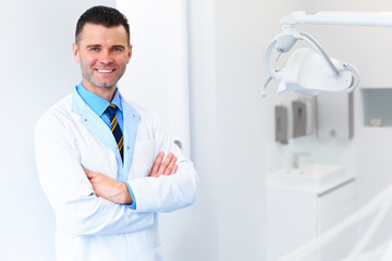 Dentist Doctor Portrait. Young Man at His Workplace. Dental Clinic