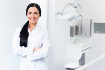 Dentist Portrait. Woman Smiling at her Workplace. Dental Clinic