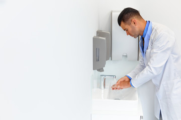 Naklejka na ściany i meble Doctor Washes Hands Before Medical Work. Dental Clinic