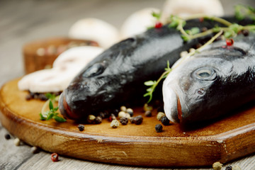 Raw seabass fish on the wooden board