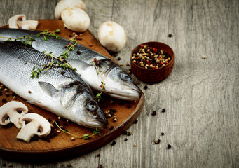 Raw seabass fish on the wooden board