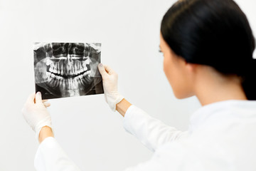 Female Dentist Looking at Dental Xray in Clinic