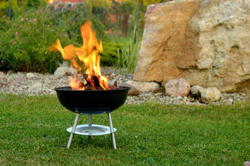 Grilling sausages over a fire