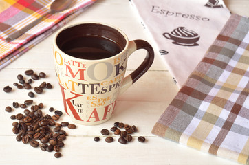 Ceramic mug of coffee on a white wooden table in Provence style