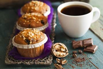 Muffin cakes in silver tray with cup of coffee