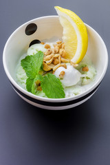 Homemade ice cream with a lime slice and mint