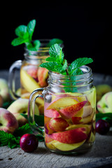 Jar delicious refreshing drink of peach fruits and plum  with mi