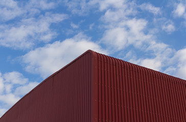 Fototapeta premium Red industrial building against a cloudy sky