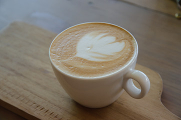 cappuccino over wooden table
