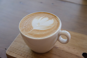 cappuccino over wooden table