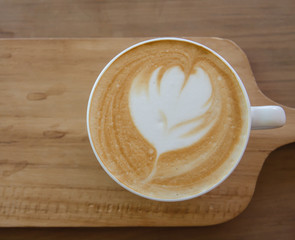 cappuccino over wooden table