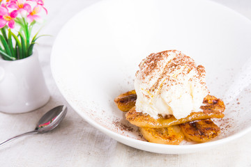 pan fried banana topped with vanilla ice cream and cocoa powder