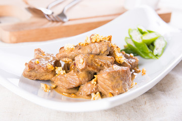 beef salpicao, or beef with creamy soy sauce topped with toasted garlic