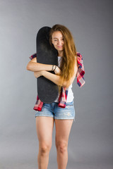 portrait of a girl with a skateboard in the Studio