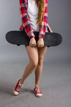 portrait of a girl with a skateboard in the Studio