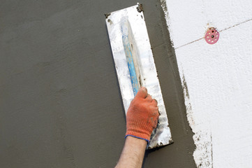applying putty to the  polyfoam wall