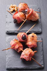 Prunes wrapped in rashers of bacon