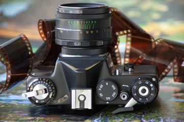 Old film camera, roll film and photos.