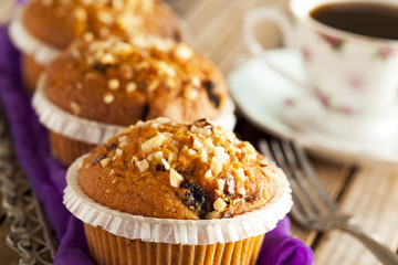 Muffin cakes in silver tray with cup of coffee