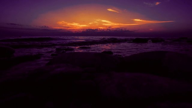 Timelapse of Amazing gold sunset on the pebble beach. 