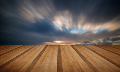 Beautiful sunset long exposure image over ocean with wooden plan