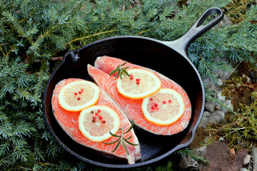 Raw  slices  salmon on frying pan