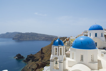 Santorini famous Orthodox church with blue domes in village Oia