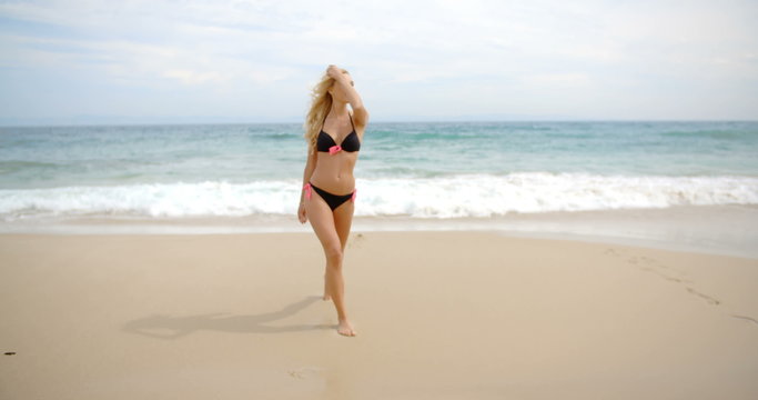 Blond Woman in Black Bikini Standing on Beach