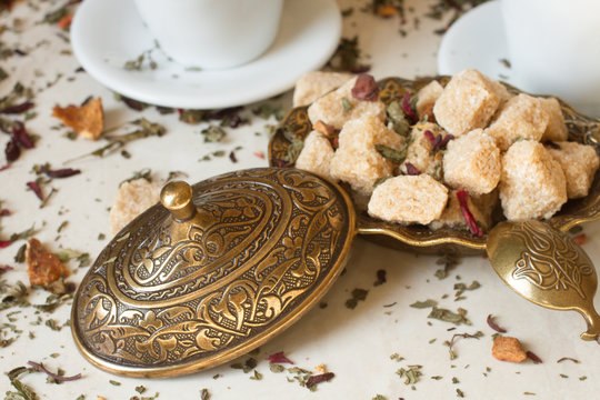 green tea in oriental style with brown sugar on a white marble