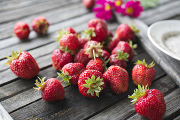 ripe red strawberries on an old wooden textured table