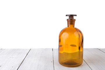 Vintage medicine bottle on wooden table isolated on white