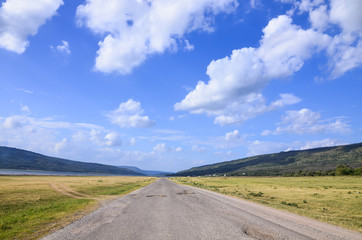 Fototapeta na wymiar Landscape of dirty road mountain blue sky and cloud