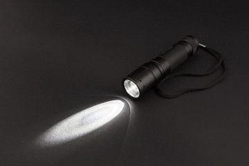 LED flashlight with a light beam - obrazy, fototapety, plakaty