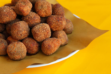 Fried potato croquettes on yellow