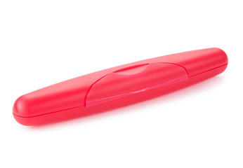 Red plastic holder for a toothbrush isolated