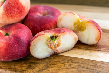 Fresh saturn peaches on wooden background © segeni