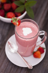 Delicious dessert protein with strawberries. Yogurt in a glass