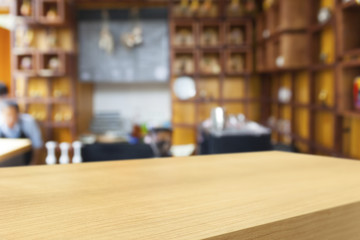 Empty wooden table and blurred cafe background