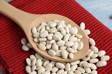 Wooden spoon with white beans