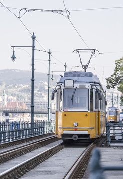Yellow tram ride along the rails