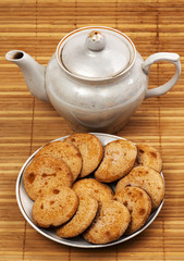 Cookies on a plate and a teapot