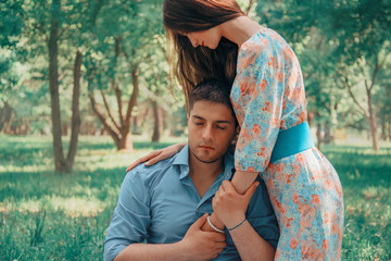 Woman hugging a man in summer park
