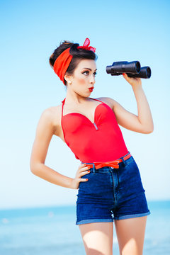 Pin-up at sea with binoculars, surprise expression