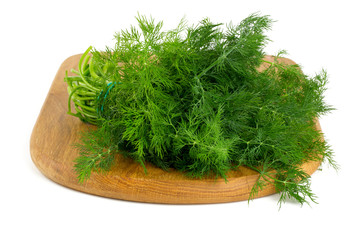 bunch of dill on cutting board isolated on white